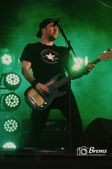 A man playing a guitar at a music concert