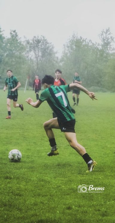 Footballers running at a football match