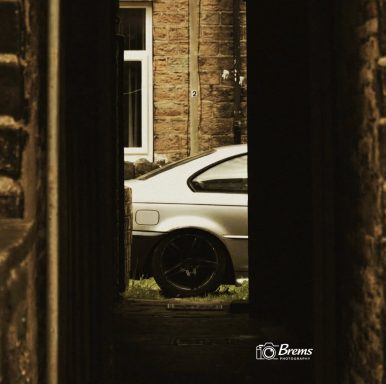A car viewed through an alley way in Huddersfield