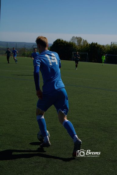 The back of a football player at a football match