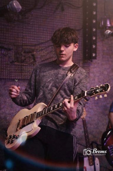 A member of Nook band playing guitar