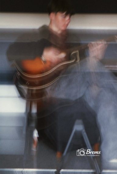A member of Nook band playing guitar