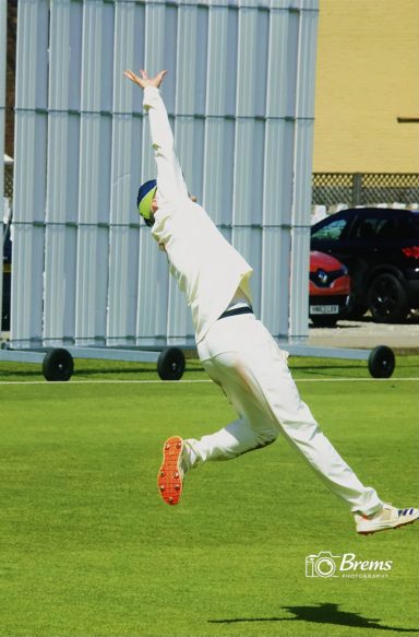 A man bowling on the cricket field at a cricket match