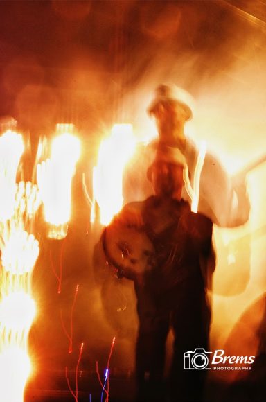 A man playing a guitar at a music concert