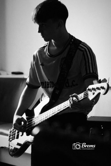 A member of Nook band playing guitar