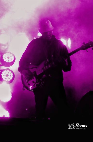 A man playing a guitar at a music concert