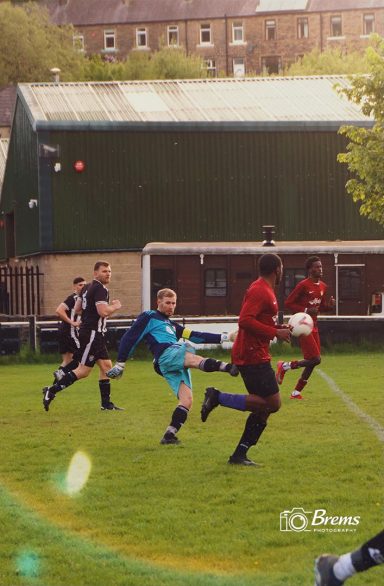 Football players at a football match passing the ball