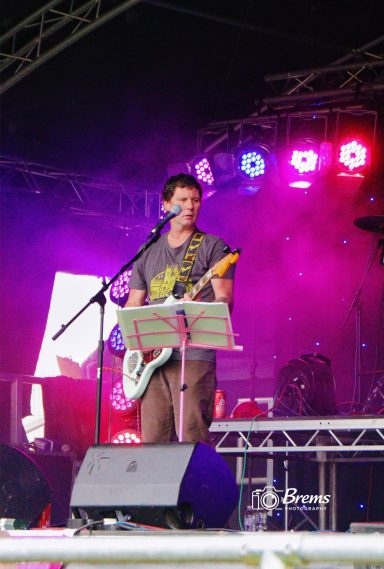 A man playing a guitar at a music concert