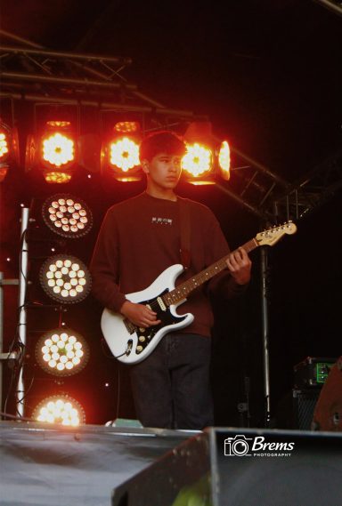 A member of Nook band playing guitar