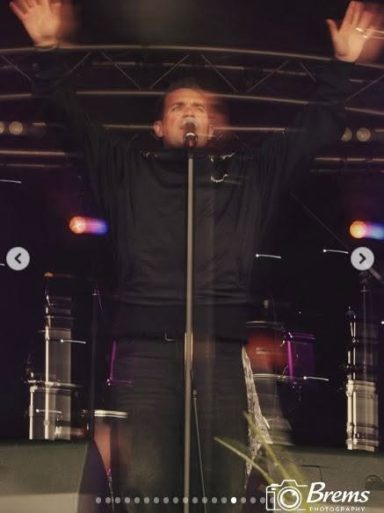 A man singing at a music concert